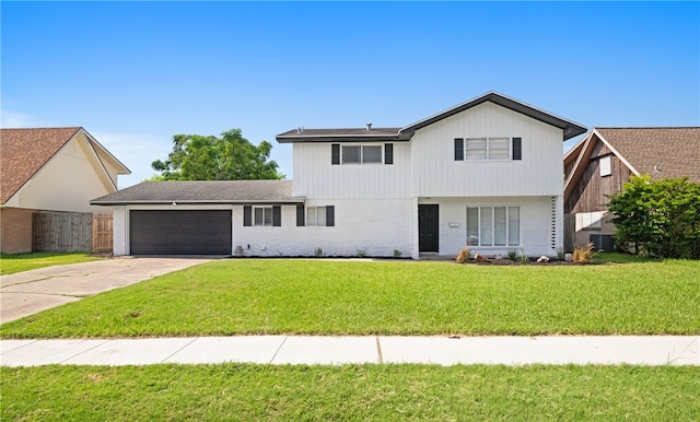 view of front property featuring a garage and a front lawn