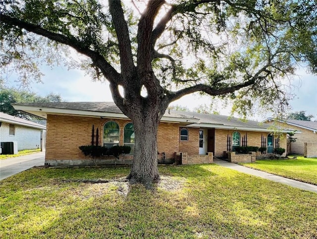 ranch-style house featuring central AC and a front yard