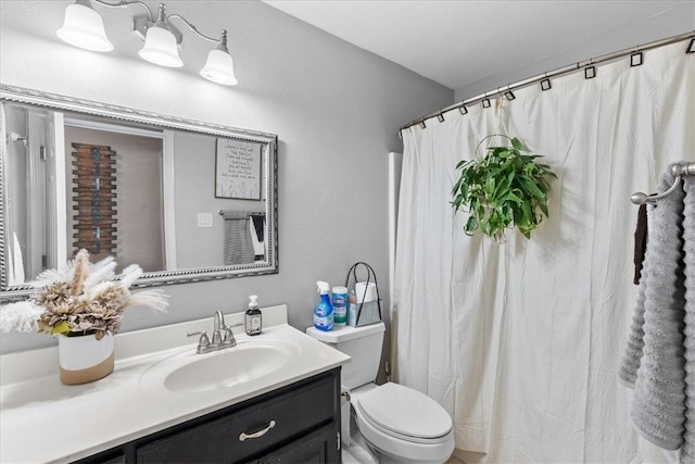 bathroom with toilet and vanity