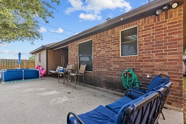 view of patio / terrace featuring fence