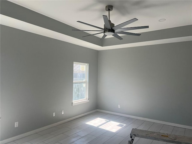 unfurnished room with ceiling fan and baseboards