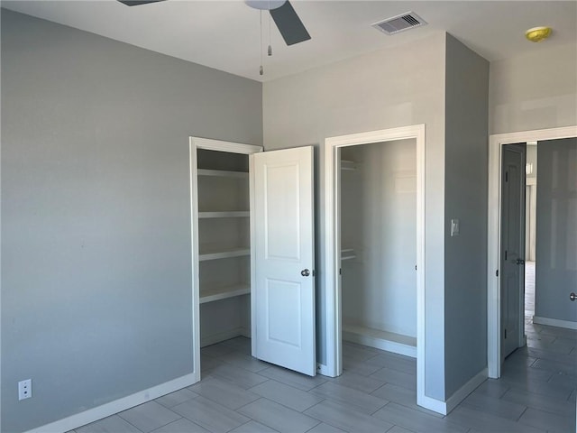 unfurnished bedroom with a ceiling fan, a closet, visible vents, and baseboards