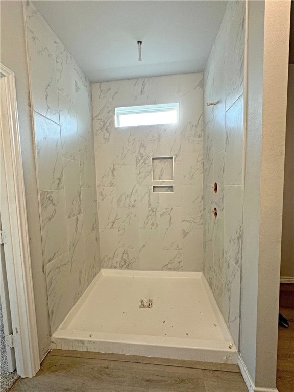 bathroom featuring wood-type flooring and walk in shower