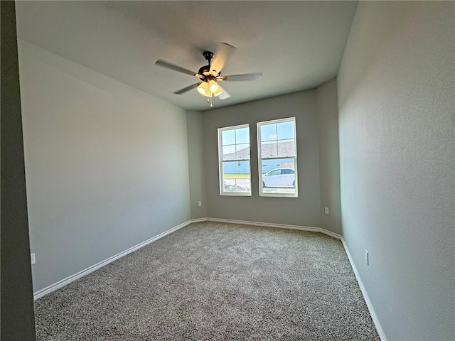 carpeted empty room featuring ceiling fan