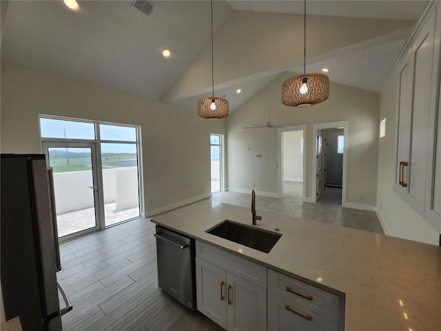 kitchen featuring hanging light fixtures, stainless steel appliances, a sink, visible vents, and open floor plan