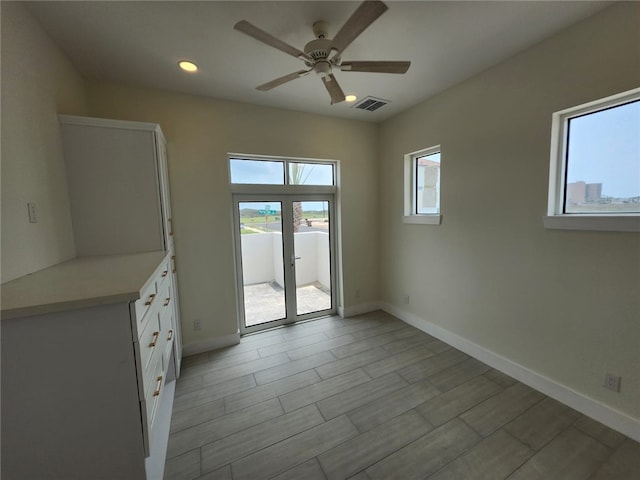 interior space with light wood-style flooring, visible vents, baseboards, recessed lighting, and a ceiling fan
