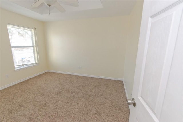 carpeted spare room featuring ceiling fan