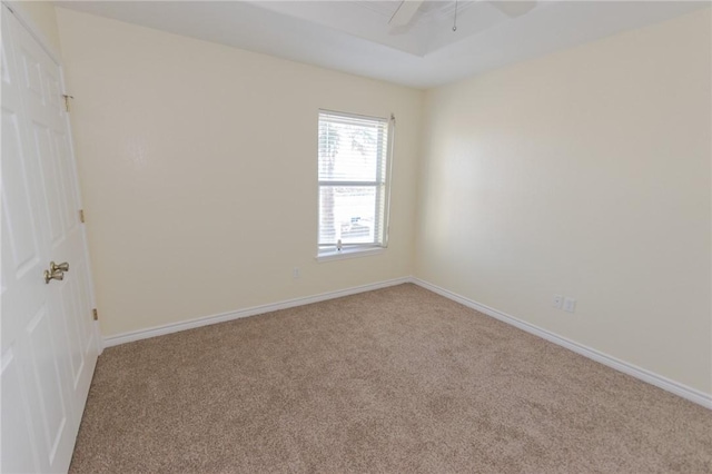 empty room featuring light colored carpet and ceiling fan