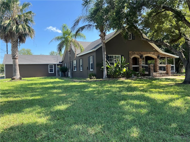 back of property featuring a yard