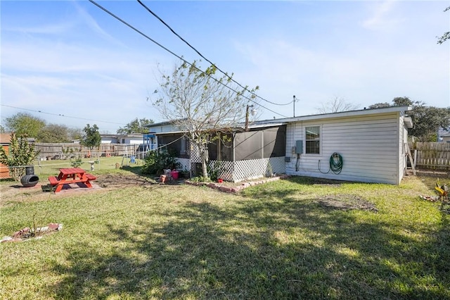 back of house featuring a lawn