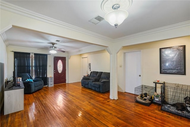 living room with hardwood / wood-style flooring, ornamental molding, and ceiling fan