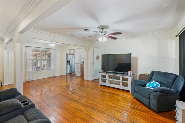 living room with crown molding, ceiling fan, and wood-type flooring