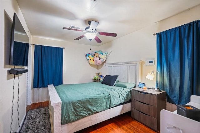 bedroom featuring dark wood-type flooring and ceiling fan