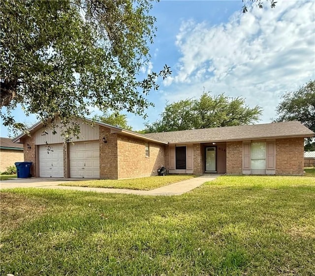 514 Vista Dr, Odem, TX 78370 - ranch-style home with a garage, brick siding, a front lawn, and concrete driveway