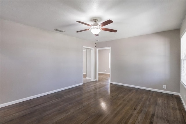 1337 Daytona Dr, Corpus Christi, TX 78415 - spare room featuring a ceiling fan, baseboards, and dark wood-style flooring