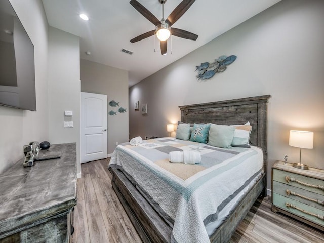 bedroom with ceiling fan and hardwood / wood-style flooring