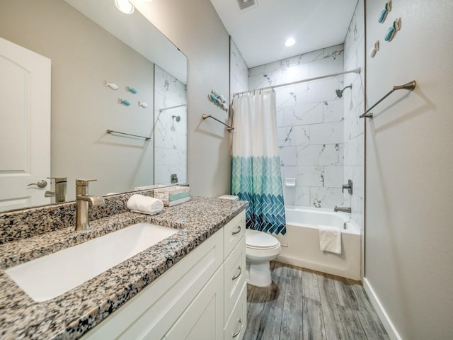 full bathroom with hardwood / wood-style flooring, toilet, vanity, and shower / tub combo with curtain