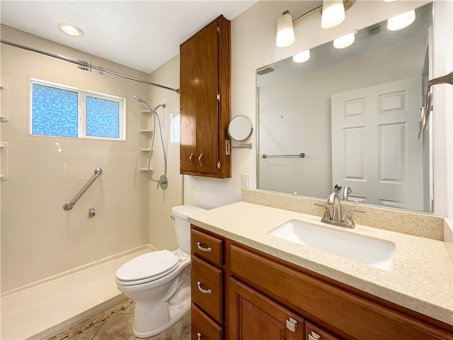 bathroom featuring vanity, toilet, and a shower