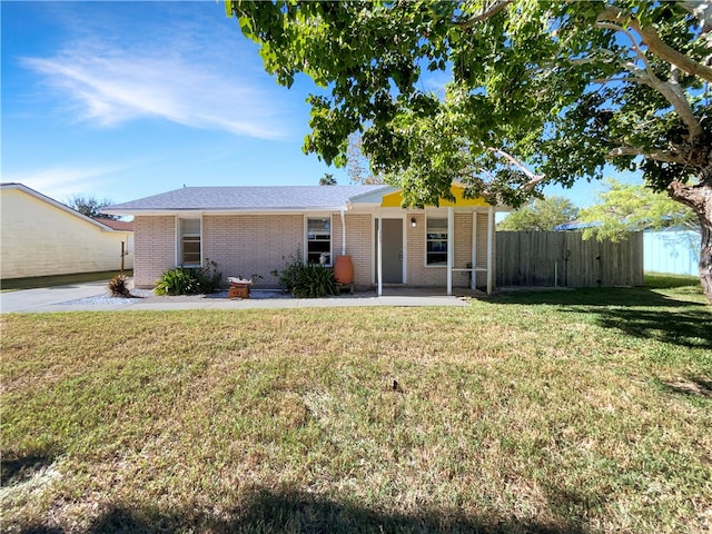 ranch-style house with a front lawn and a patio