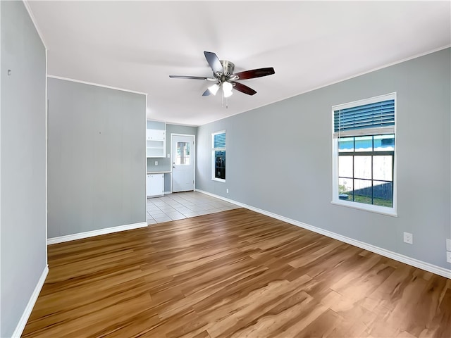 unfurnished living room featuring ceiling fan and light hardwood / wood-style flooring