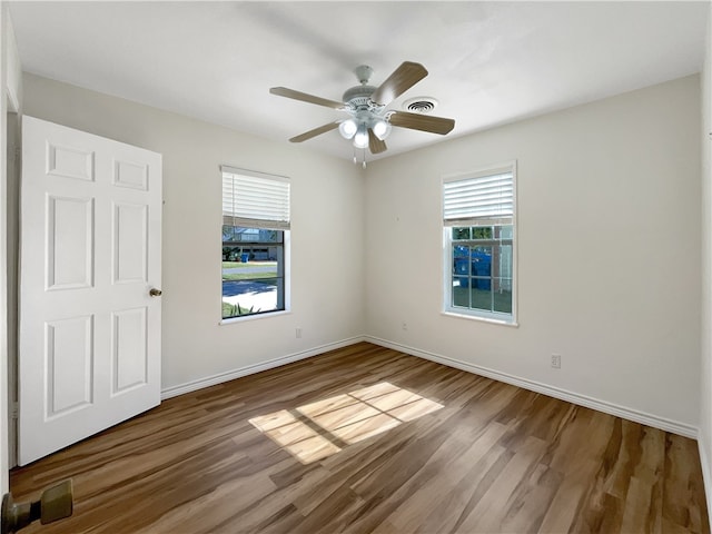 unfurnished room with ceiling fan and wood-type flooring