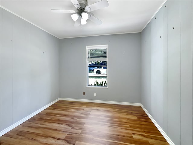 spare room with ceiling fan, light wood-type flooring, and ornamental molding