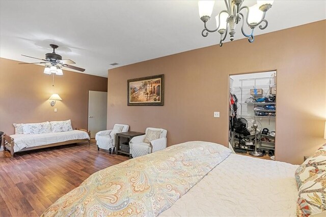 24475 La Ponderosa Dr, Mathis, TX 78368 - bedroom featuring a chandelier, wood finished floors, a spacious closet, a closet, and ceiling fan