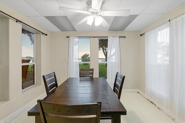 dining space featuring a paneled ceiling, a healthy amount of sunlight, and ceiling fan