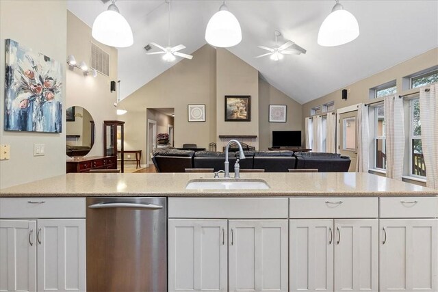 24475 La Ponderosa Dr, Mathis, TX 78368 - kitchen with open floor plan, a ceiling fan, dishwasher, white cabinetry, and high vaulted ceiling