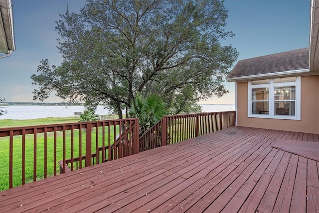 wooden deck featuring a yard and a water view