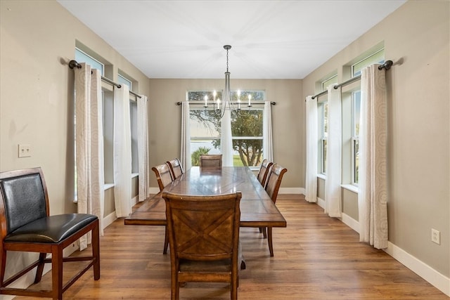 dining room featuring hardwood / wood-style floors and an inviting chandelier