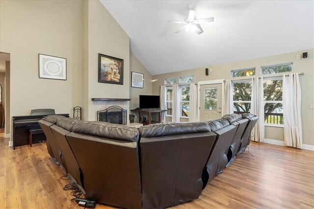 24475 La Ponderosa Dr, Mathis, TX 78368 - living area featuring a ceiling fan, high vaulted ceiling, light wood-style floors, and a fireplace