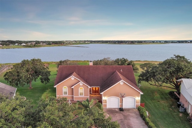 aerial view at dusk with a water view