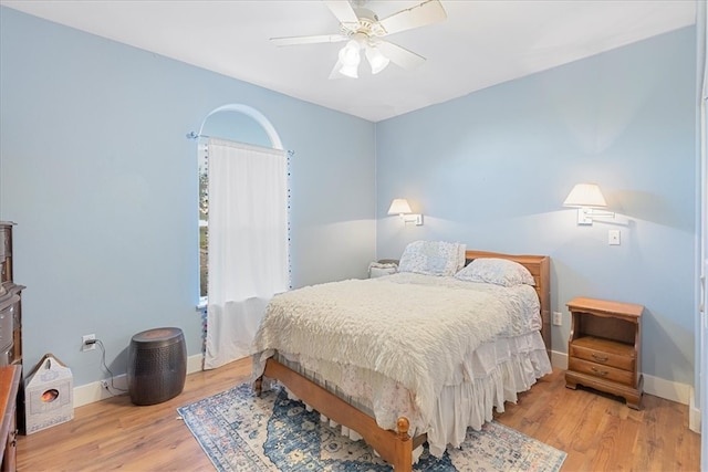 bedroom with light hardwood / wood-style floors and ceiling fan