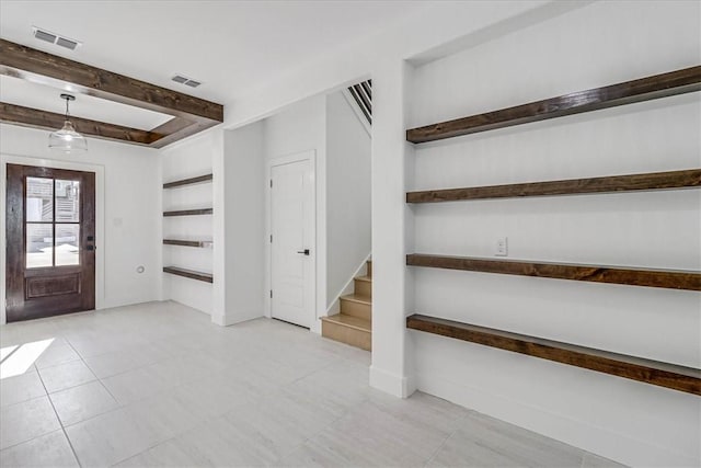 foyer with beamed ceiling