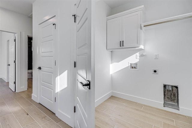 laundry room featuring cabinets, hookup for a washing machine, hookup for an electric dryer, and hookup for a gas dryer