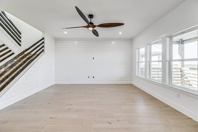 unfurnished living room with ceiling fan, light hardwood / wood-style flooring, and a wealth of natural light