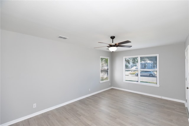 spare room featuring light hardwood / wood-style floors and ceiling fan