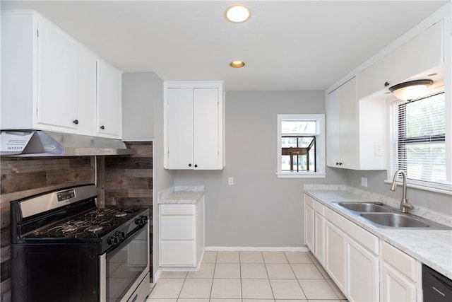 kitchen with white cabinets, a wealth of natural light, stainless steel range with gas stovetop, and sink