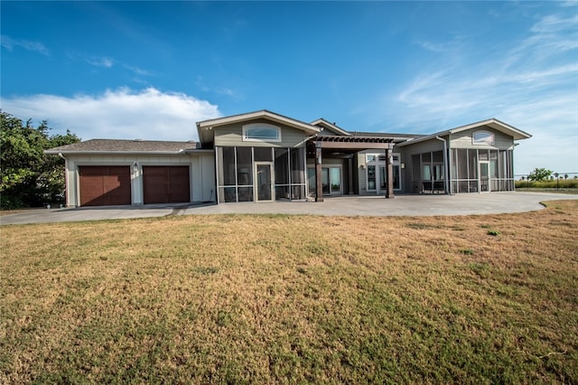 single story home with a front lawn, a garage, a sunroom, and a patio