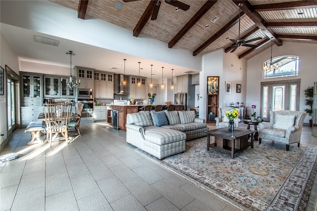 living room with high vaulted ceiling, beam ceiling, and an inviting chandelier