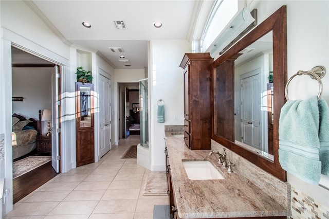 bathroom with hardwood / wood-style floors, plenty of natural light, vanity, and ornamental molding