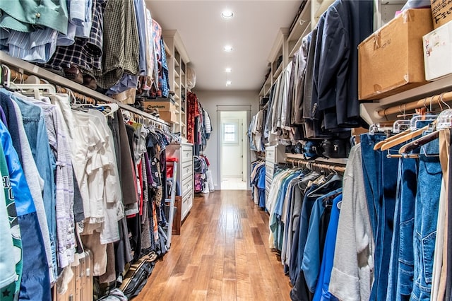 walk in closet with light wood-type flooring