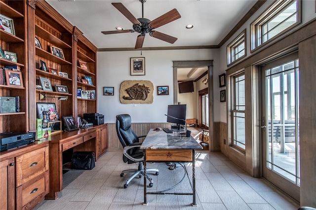 office featuring crown molding, wooden walls, and ceiling fan