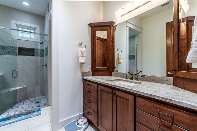 bathroom featuring walk in shower, vanity, and tile patterned floors