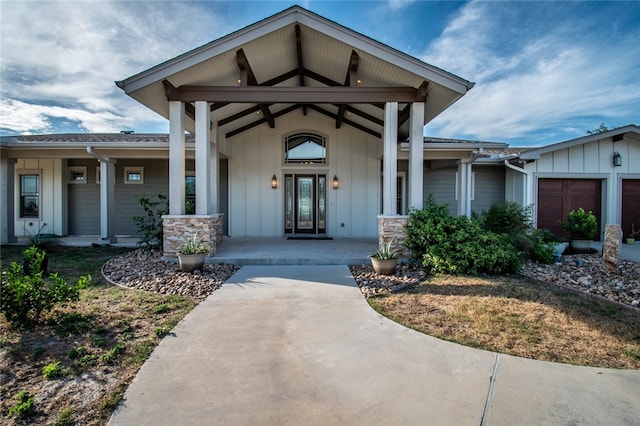 entrance to property featuring a porch and a garage