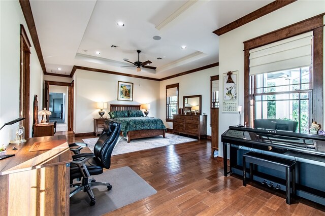 bedroom with a tray ceiling, wood-type flooring, and crown molding