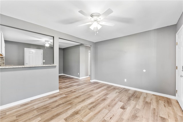 empty room featuring ceiling fan and light hardwood / wood-style floors