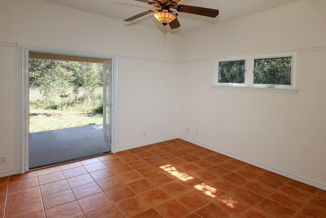 tiled spare room with ceiling fan