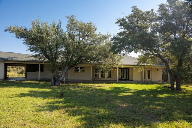 back of house with a yard